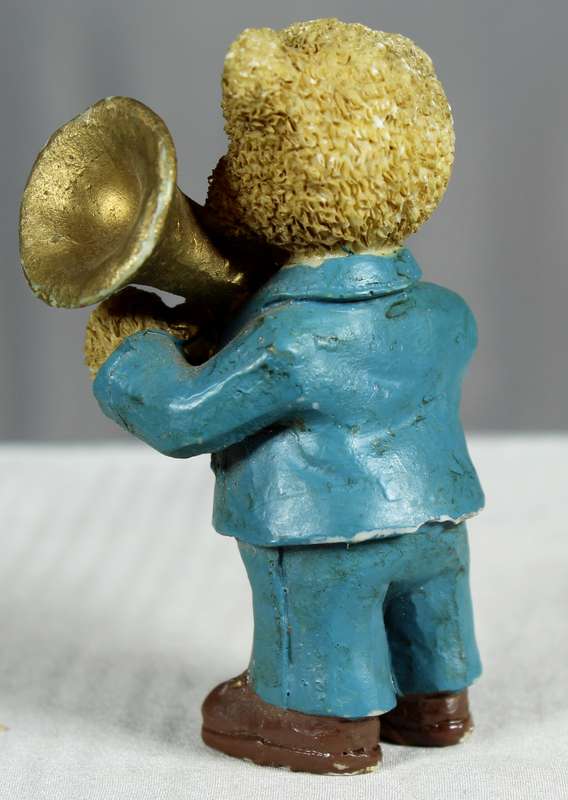 Little boy bear in blue suit with musical instrument