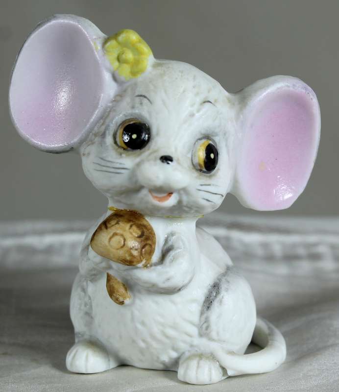 Mouse holding a mushroom