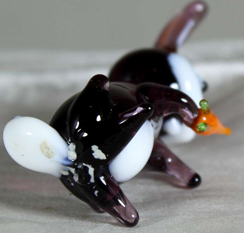 Glass rabbit seated with carrot