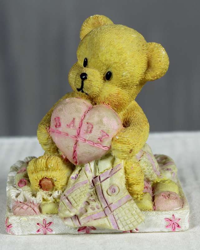 Baby girl bear with pink heart in hands