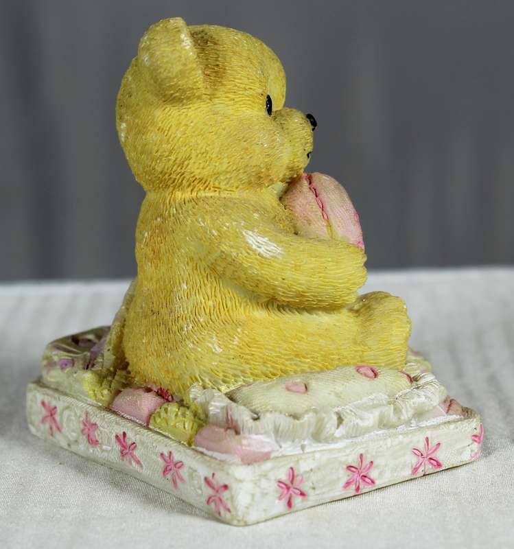 Baby girl bear with pink heart in hands