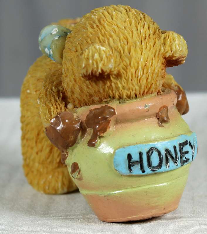 Bear with face in honey pot