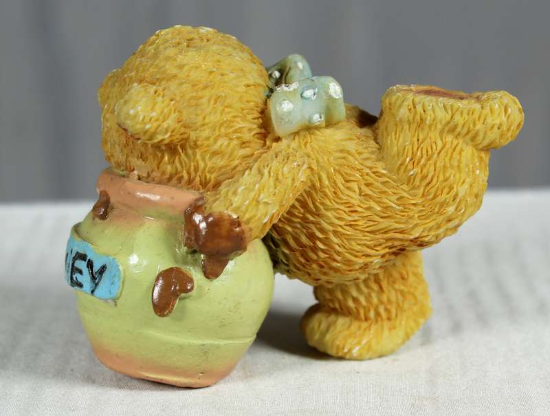 Bear with face in honey pot