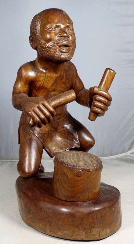 Cande - carved man playing the drums