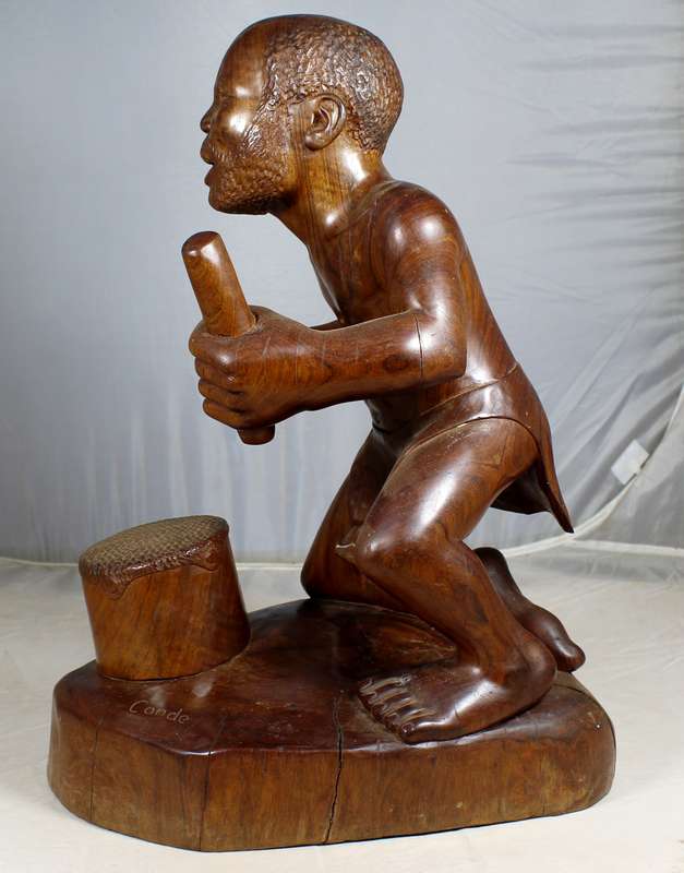 Cande - carved man playing the drums