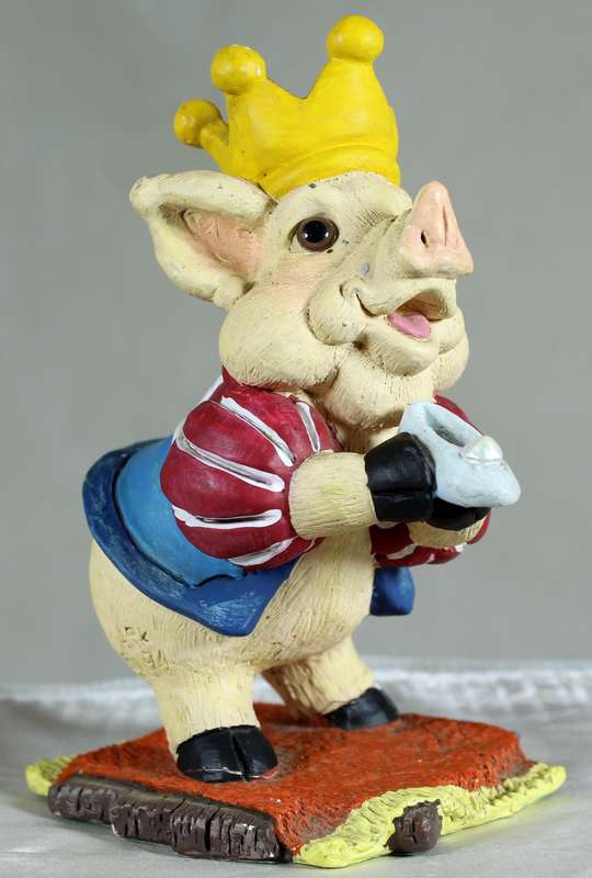 Pig king holding a shoe
