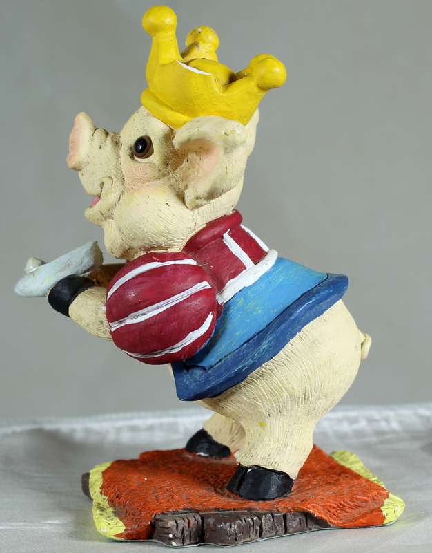 Pig king holding a shoe