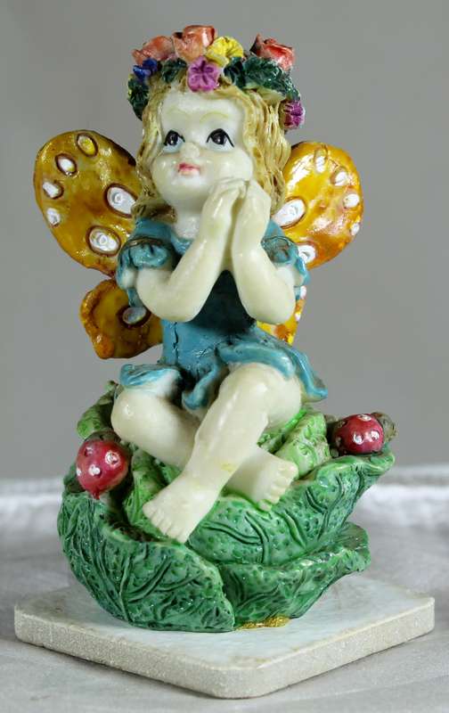 Seated fairy making a wish