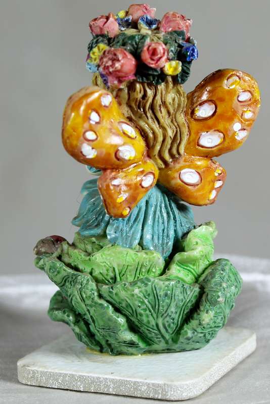 Seated fairy making a wish