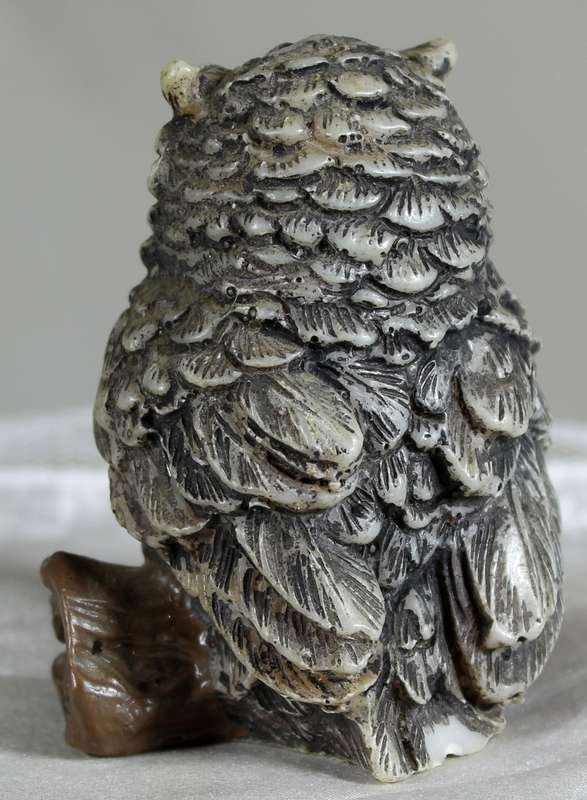 Owl seated on a log