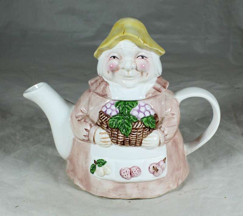 Ornamental porcelain kettle in the shape of an old woman