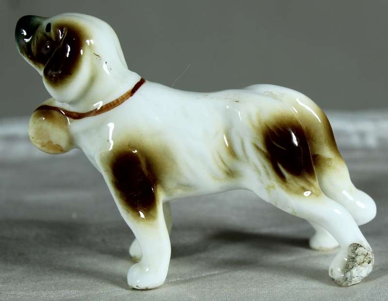 Miniature porcelain dog with barrel