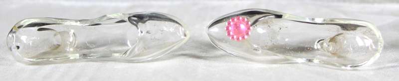 Miniature glass pair of odd high heel shoes