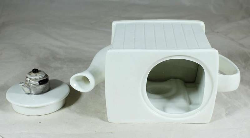 Ornamental porcelain kettle in the shape of a fireplace