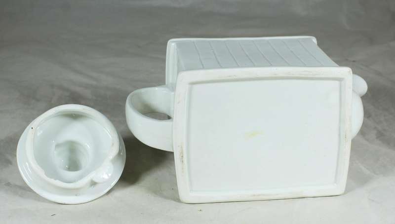 Ornamental porcelain kettle in the shape of a fireplace