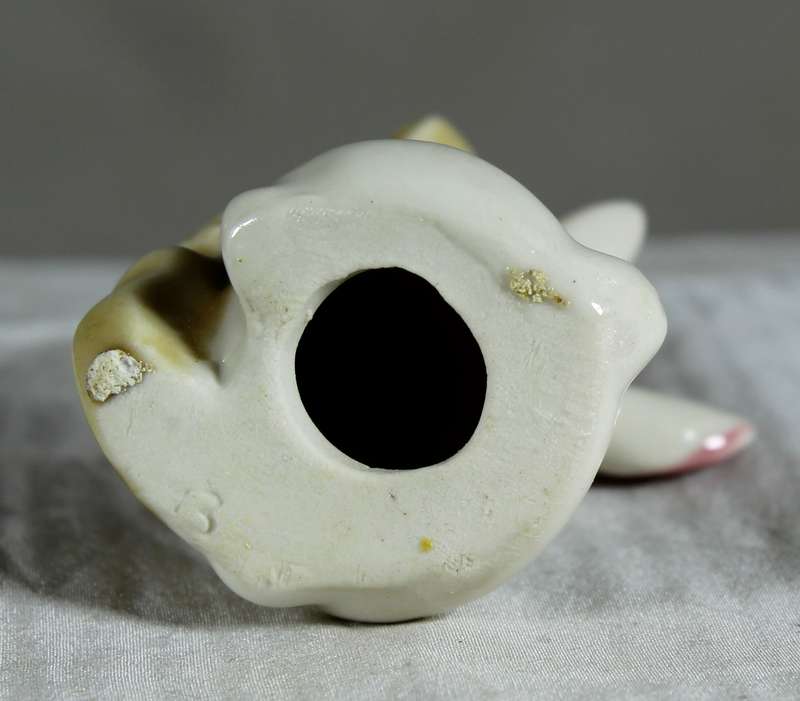 Miniature glazed ceramic bunny playing a bass