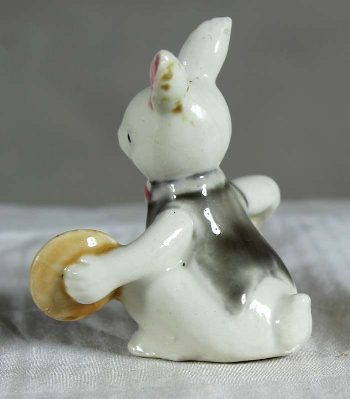 Miniature glazed ceramic bunny playing cymbals