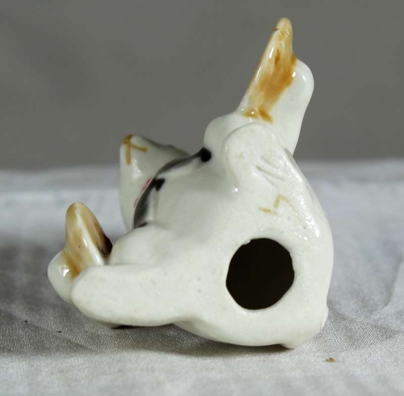 Miniature glazed ceramic bunny playing cymbals