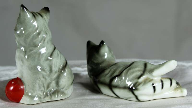 Pair of cats playing with red balls
