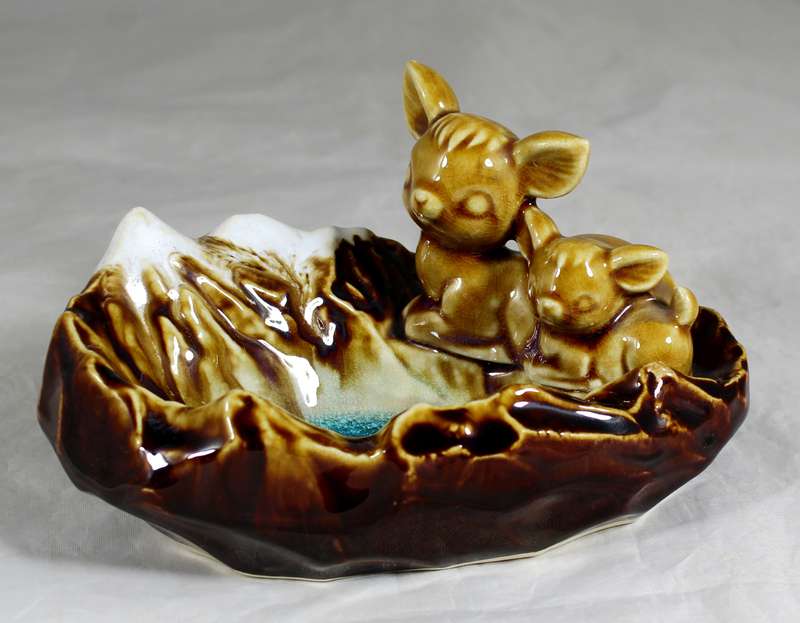 Glazed ceramic ashtray with sleeping bucks