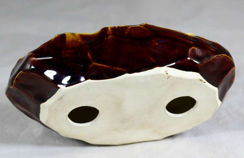 Glazed ceramic ashtray with sleeping bucks
