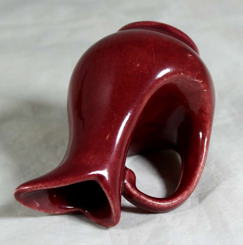 Small burgundy jug with rock art