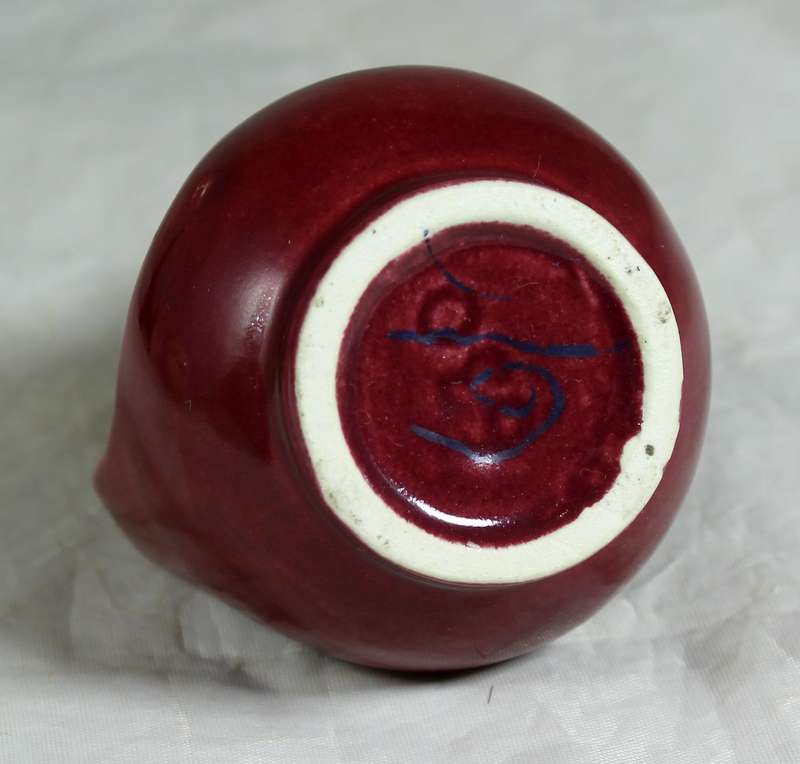 Small burgundy jug with rock art