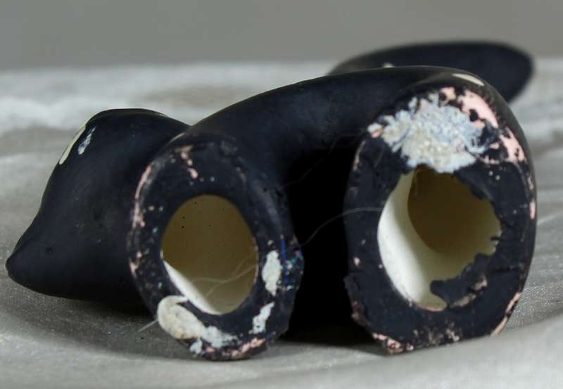 Ceramic cat with very long tail