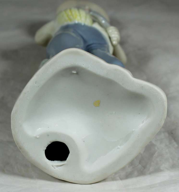Porcelain farmer with picked wheat