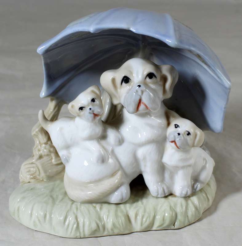 Porcelain dog with puppies under an umbrella