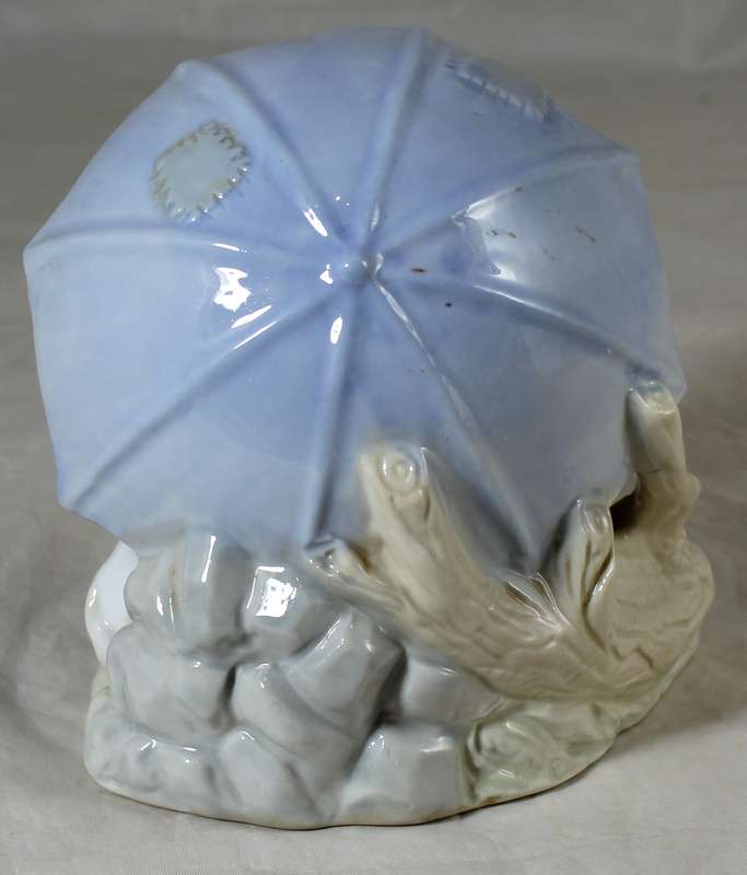 Porcelain dog with puppies under an umbrella