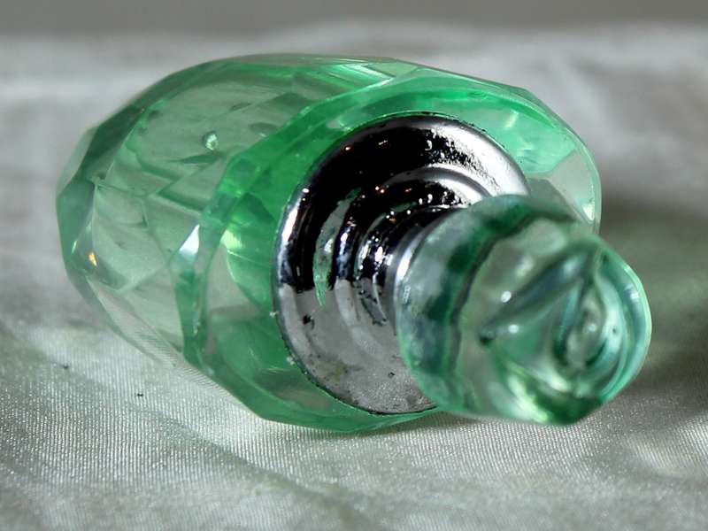 Miniature green glass perfume bottle