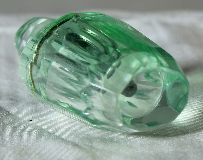Miniature green glass perfume bottle