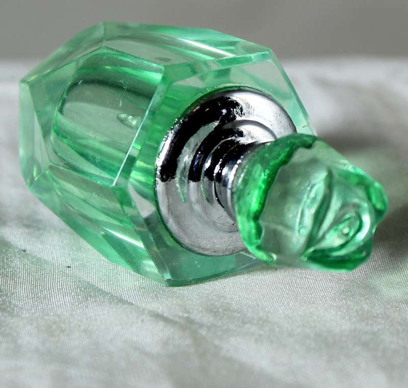 Miniature green glass perfume bottle