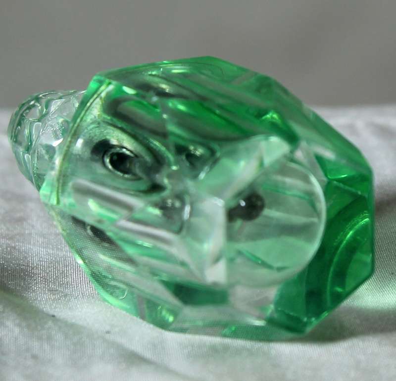 Miniature green glass perfume bottle
