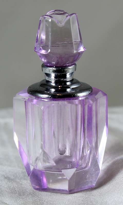 Miniature purple glass perfume bottle