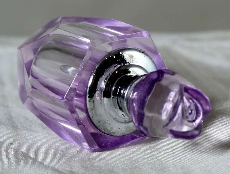 Miniature purple glass perfume bottle