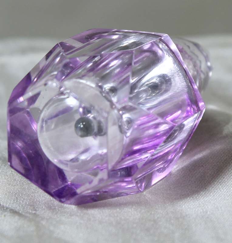 Miniature purple glass perfume bottle