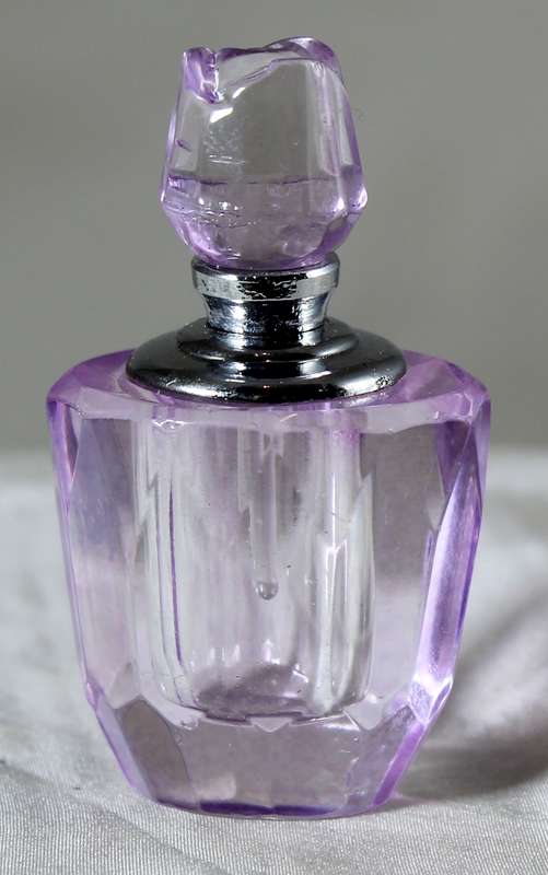 Miniature purple glass perfume bottle
