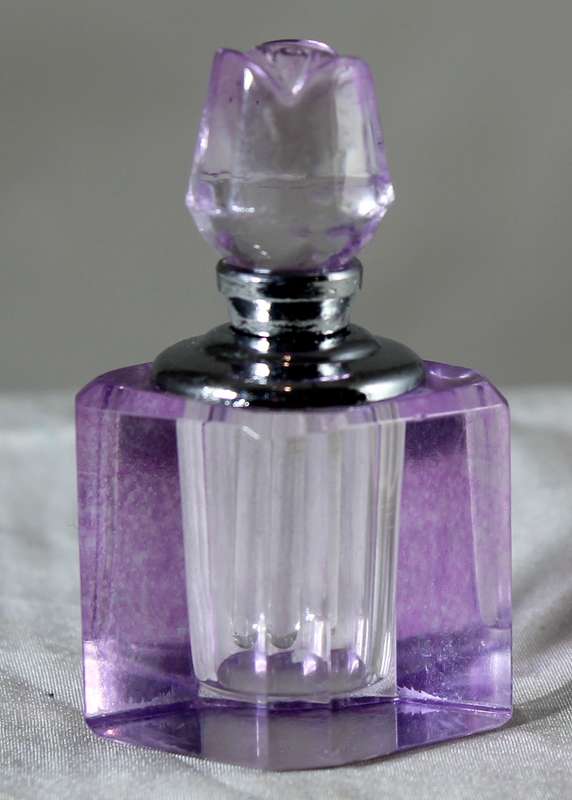 Miniature purple glass perfume bottle