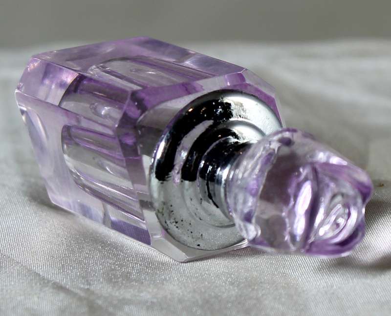 Miniature purple glass perfume bottle