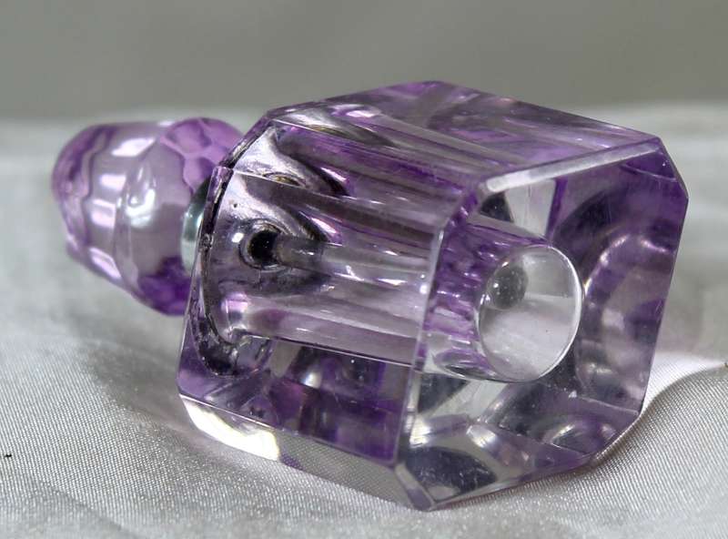 Miniature purple glass perfume bottle