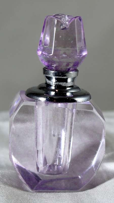 Miniature purple glass perfume bottle