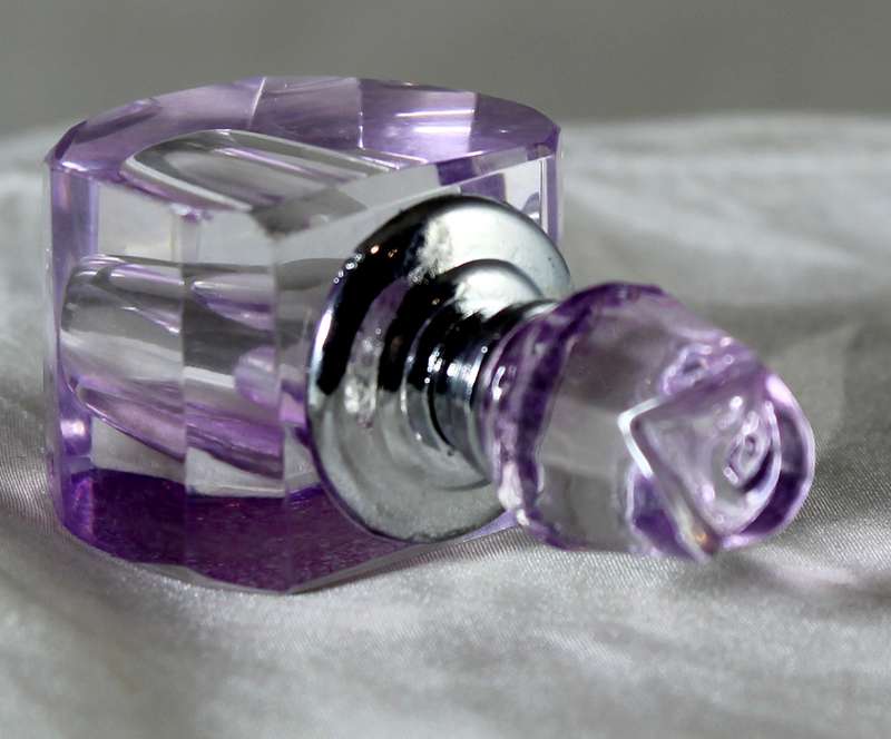 Miniature purple glass perfume bottle