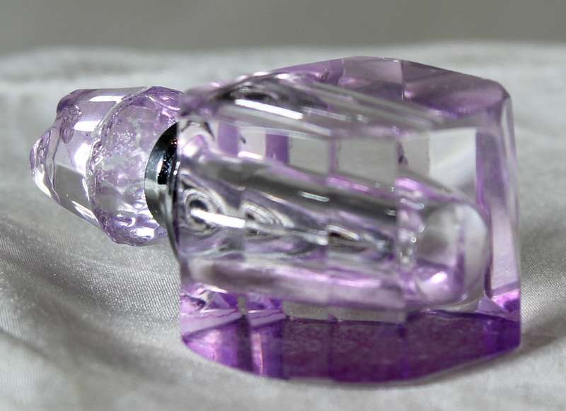 Miniature purple glass perfume bottle