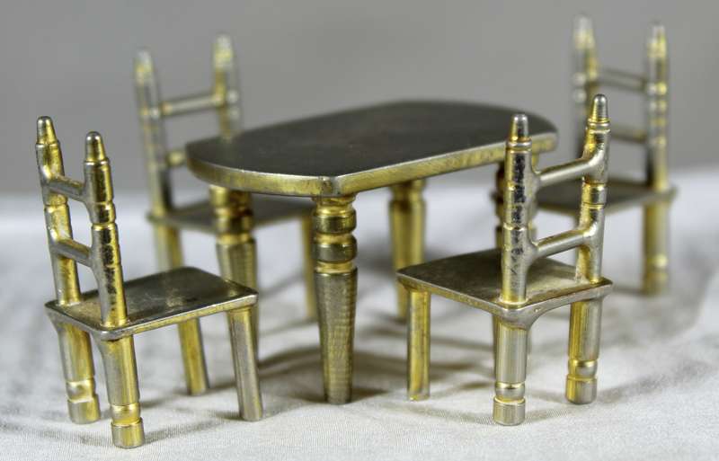 Miniature brass table with four chairs