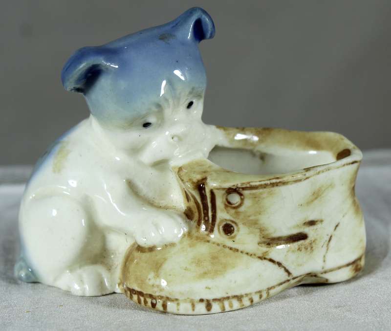 Porcelain doggy biting a shoe