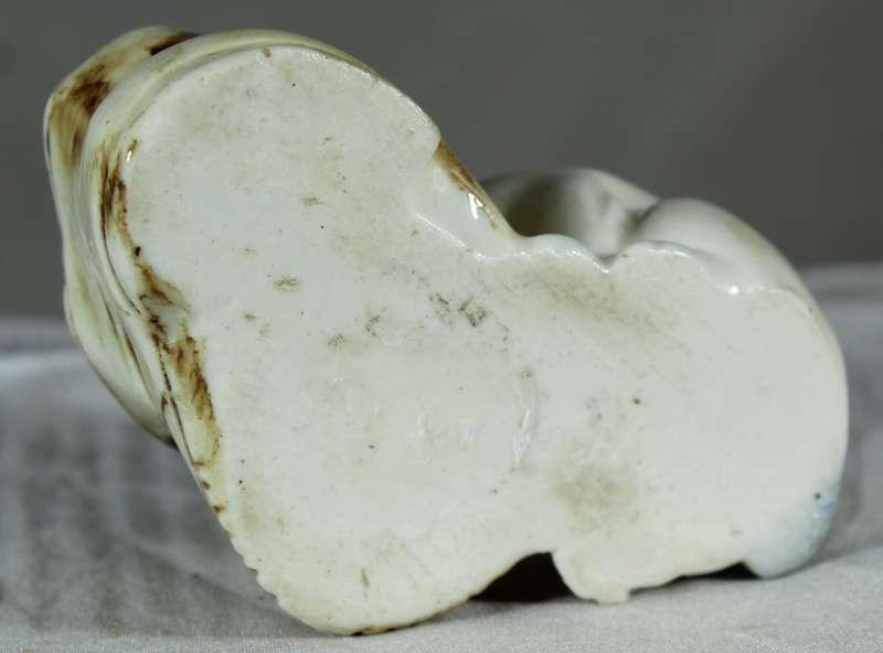 Porcelain doggy biting a shoe