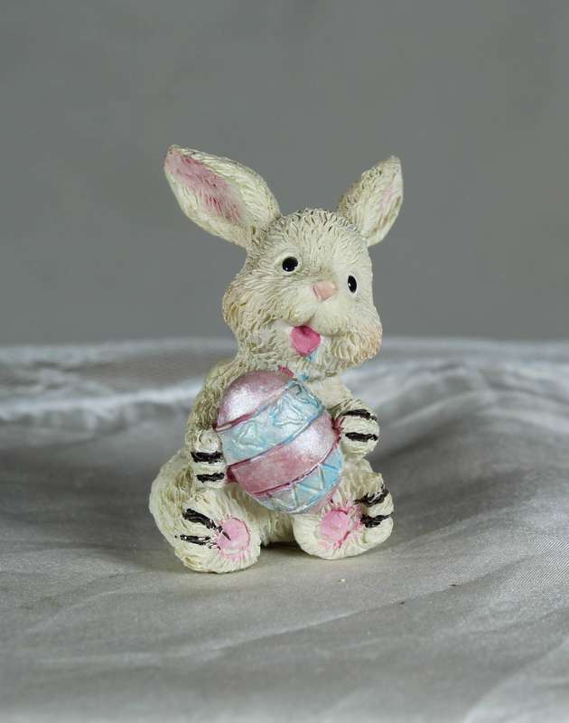 Small bunny holding an Easter egg