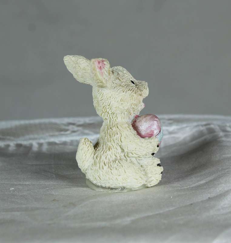 Small bunny holding an Easter egg